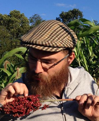 Nate Kleinman examining South Sudanese 'Nebur Der' sorghum in Elmer, NJ.